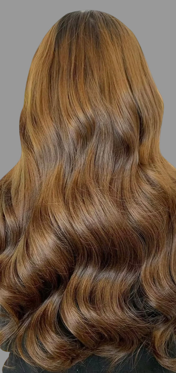 Brown hair extensions with a full head of styled hair on a white background
